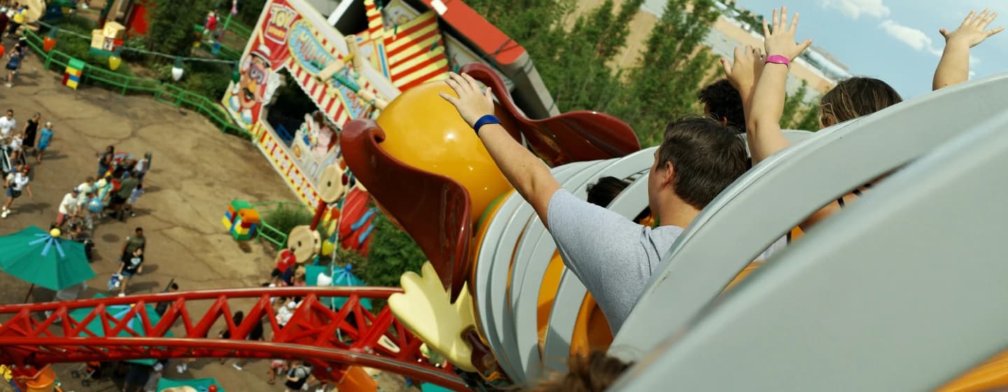 people riding a rollercoaster representing delivering brand love at pace