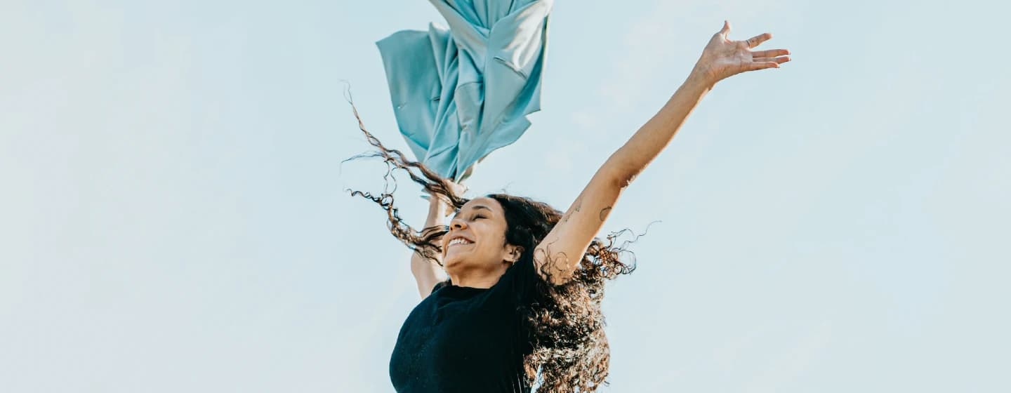 a woman jumping in thee air, representing joy at firefish being shortlisted for awards in 2017