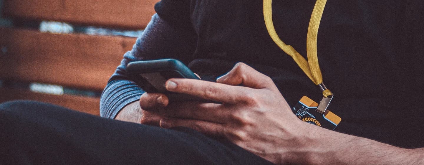 a close up of a man's hans on his phone, representing discovery mindset when on twitter